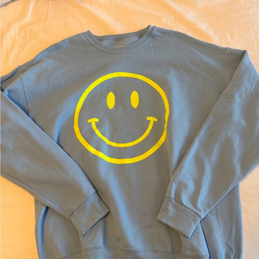 Dressed in LALA Blue Sweatshirt with Yellow Smiley Graphic